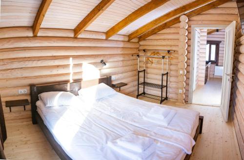 a bedroom in a log cabin with a bed at Шале Вілія in Vorokhta