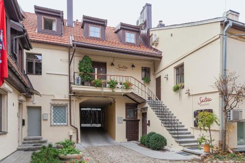 a building with a staircase in front of it at Apartments Satva in Vilnius