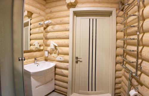 a bathroom with a toilet and a sink in it at Шале Вілія in Vorokhta