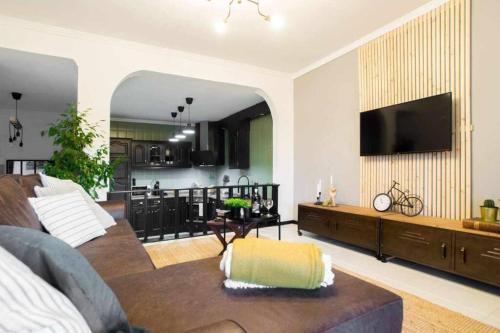 a living room with a couch and a flat screen tv at Regouro - an Hidden Gem in Douro Valley in Boassas
