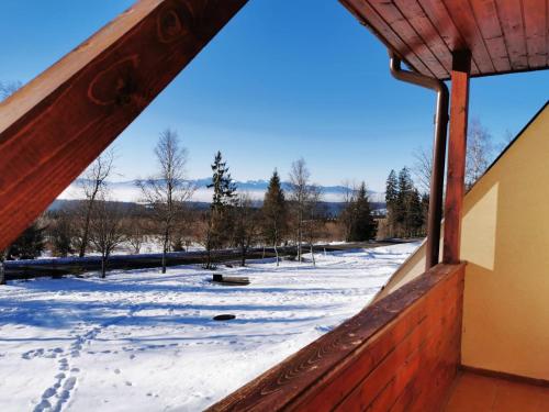 a view of a snow covered field from a building at Tri studničky Správa TANAPu in Vysoké Tatry