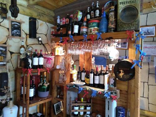 a bar with a bunch of bottles of wine at Pualy Resort & Spa in Belén de Escobar