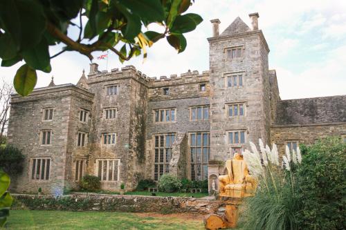 an old castle with a statue in front of it at Boringdon Hall Hotel and Spa in Plymouth