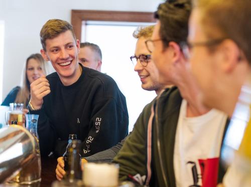 a group of men sitting at a table together at Hagen`s Hotel "eat & meet" Restaurant Bar Lounge in Haren