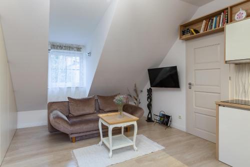 a living room with a couch and a table at Apartments Satva in Vilnius