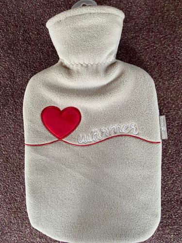 a white bottle with a red heart on it at Ferienwohnung Paulina in Braunschweig
