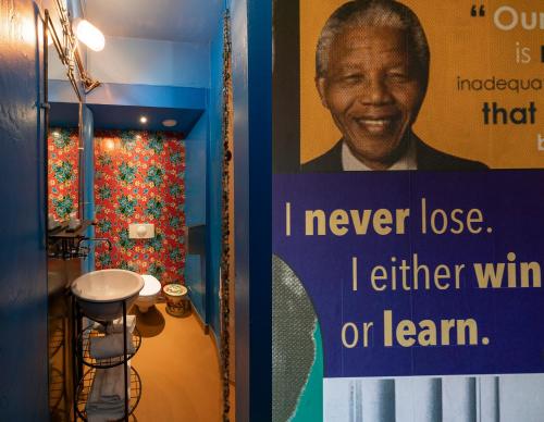a sign in a bathroom with a poster at Hotel Bazar in Rotterdam