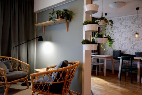 a room with chairs and a table with plants on the wall at Duvan Hotell & Konferens in Uppsala
