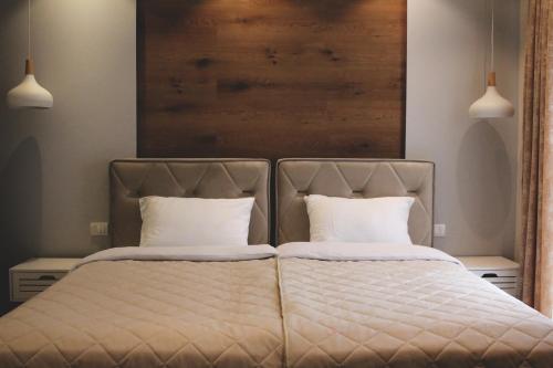 a bedroom with a bed with two pillows at Ecco Superior in Novi Pazar