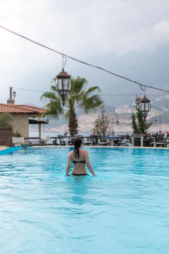 a woman in the water in a swimming pool at Club Hotel Barbarossa in Kas