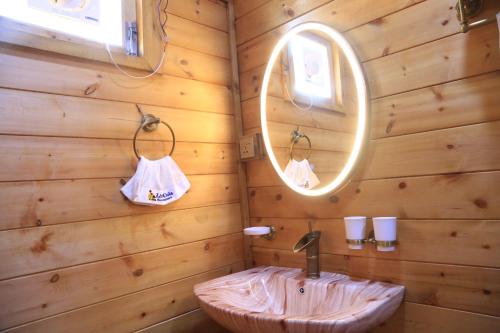 a bathroom with a sink and a mirror at Cola Goa Beach Resort in Cola