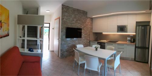 a kitchen and dining room with a table and chairs at Villaggio Mare Blu in Bibione