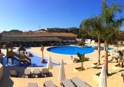 a large swimming pool with chairs and umbrellas at Camping Tucan - Mobile Homes by Lifestyle Holidays in Lloret de Mar