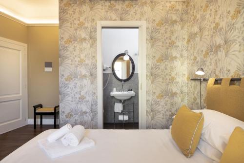 a bathroom with a bed and a sink and a mirror at Parione Uno in Florence
