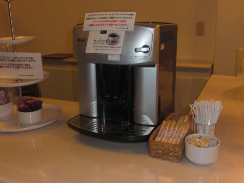 a coffee maker sitting on top of a counter at Sunsky Hotel in Kitakyushu