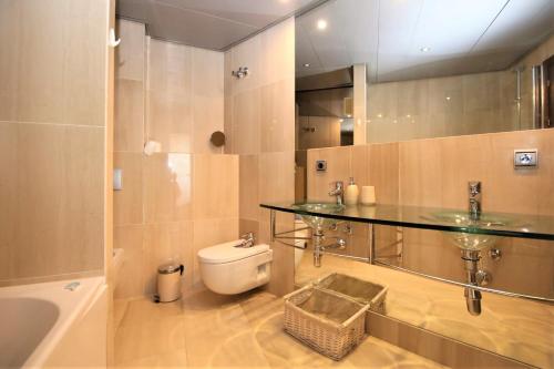 a bathroom with a toilet and a glass counter at Estepona East Apartment MIA in Estepona