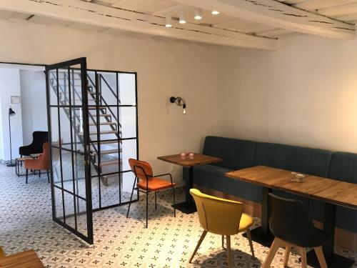 a dining room with tables and chairs and a ladder at Fügekert - Bed&Wine in Zánka