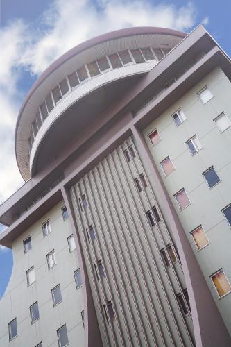 a large white building with a dome on top at Sunsky Hotel in Kitakyushu