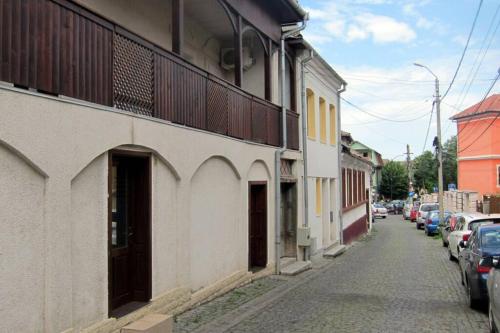 a street with cars parked on the side of a building at Studio 6 in Târgu-Mureş