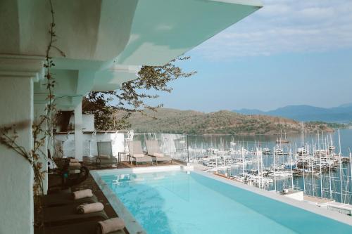 a swimming pool with a view of a marina at Casa Margot Hotel - Adults Only in Fethiye