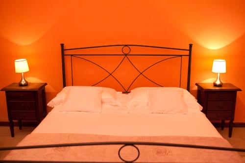 a bedroom with a bed with two lamps on tables at B&B Dimora San Vincenzo in Gallipoli
