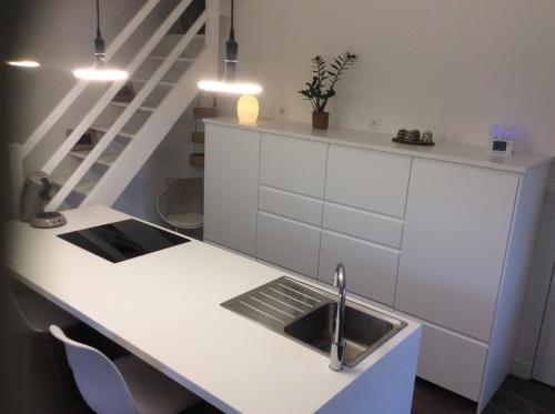 a kitchen with a sink and a counter at Casa Cosy in Lesneven