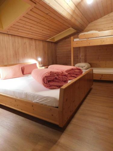 a bedroom with two bunk beds in a cabin at Ferienwohnungen Pension Prünster in Maria Luggau