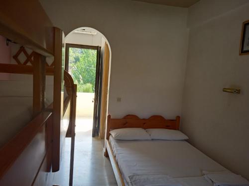 a bedroom with a bed and an open doorway at Santa Maria in Vitalades