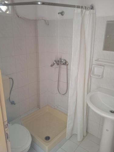a bathroom with a shower with a toilet and a sink at Santa Maria in Vitalades