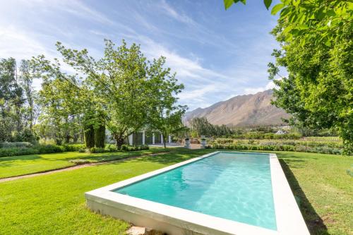 a swimming pool in the yard of a house at Klein Nektar Wine & Olive Estate in Montagu