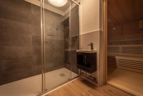 a bathroom with a shower and a sink at Chalet Pinnacle in Saas-Fee
