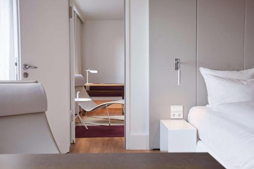 a small bedroom with a bed and a table at Scandic Frankfurt Museumsufer in Frankfurt/Main