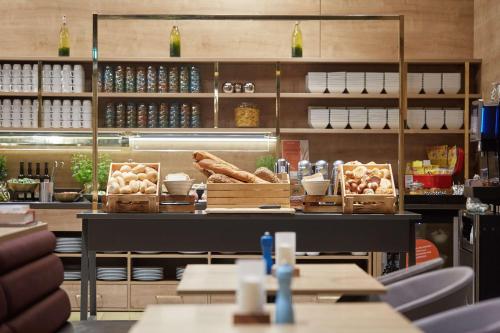 a bakery with bread and other food items on display at Scandic Frankfurt Museumsufer in Frankfurt/Main