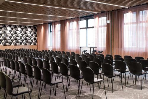 an empty room with chairs and tables in it at Scandic Frankfurt Museumsufer in Frankfurt/Main