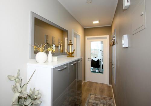 a hallway with a counter with vases on it at Appartement MEERzeit in Wenningstedt