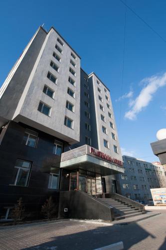 a tall black building with stairs in front of it at Platinum Hotel Ulaanbaatar in Ulaanbaatar
