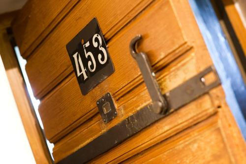 a wooden door with the number on it at Långholmen Hotell in Stockholm