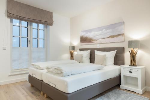 Postel nebo postele na pokoji v ubytování Strandgut Wohnung 5