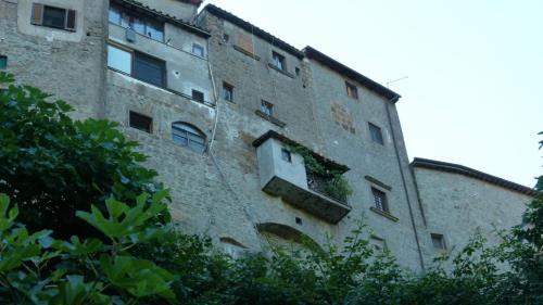 a large brick building with a window on it at La casa nel Borgo Sospeso "con vasca e vista panoramica" in Vitorchiano