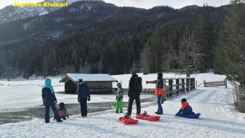 a group of people standing in the snow at M4 Appartements in Wagrain
