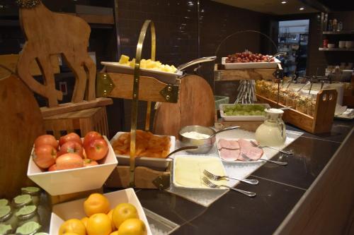 a buffet with fruits and vegetables on a counter at Estérel Resort in Esterel