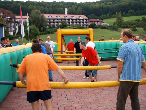 a group of people standing around a playground at Hessen Hotelpark Hohenroda in Hohenroda