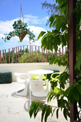 a patio with a table and chairs on a balcony at Goodnight Cha Am Minitel in Cha Am
