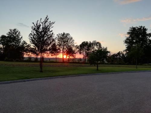 an empty road with the sunset in the background at Landhaus Schaidreith in Ferschnitz