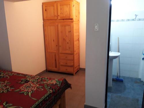 une chambre avec un meuble en bois et un lavabo dans l'établissement La Nona, à Villa Cura Brochero