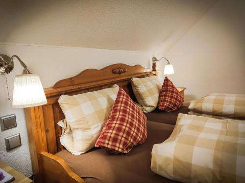 a bedroom with a bed with pillows on it at Hotel Landgasthof Sonne in Mahlberg