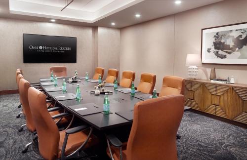 a conference room with a long table and chairs at Omni Viking Lakes in Eagan