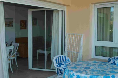 a room with a table and chairs and a balcony at Carlton Playa in Denia