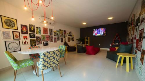 a room with a table and chairs and a tv at Kembali Hotel Porto de Galinhas - Adults Only in Porto De Galinhas