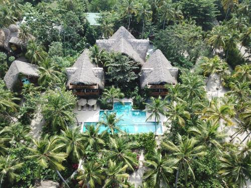 an aerial view of a resort with a swimming pool at Cayena by Masaya Collection in Guachaca